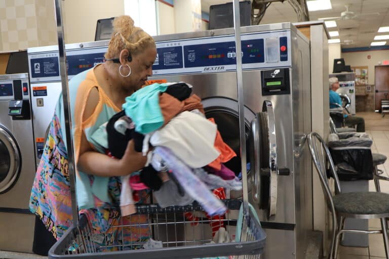 A woman in a laundry room experiencing the best laundry services Penndel offers at Laundry Depot